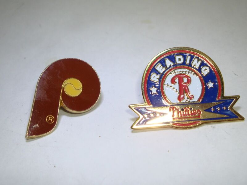Two vintage baseball pins featuring the Philadelphia Phillies and Reading Phillies logos, in mint condition.