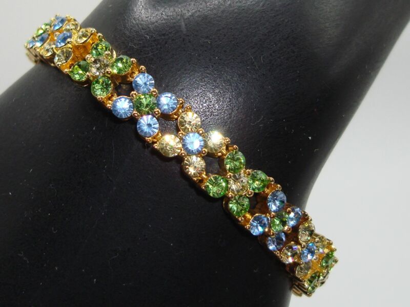 Vintage Joan Rivers gold tone CZ bracelet with sparkling blue, green, and amber stones.