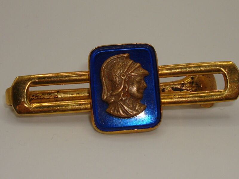 Vintage 1940s gold-tone tie bar with blue glass Centurion design