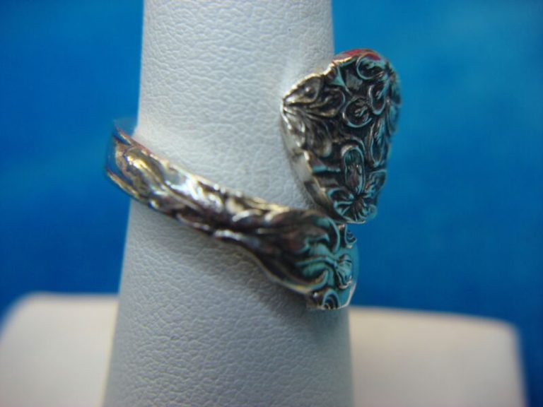 Vintage sterling silver spoon ring, size 7, with intricate design and hallmarks.