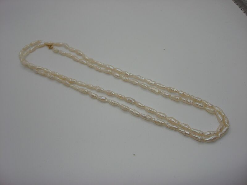 Vintage 32-inch creamy white freshwater pearl necklace with 14K gold clasp