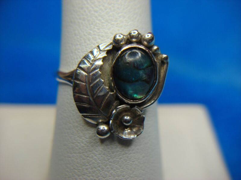 Artisan crafted sterling silver ring with iridescent stone and western style