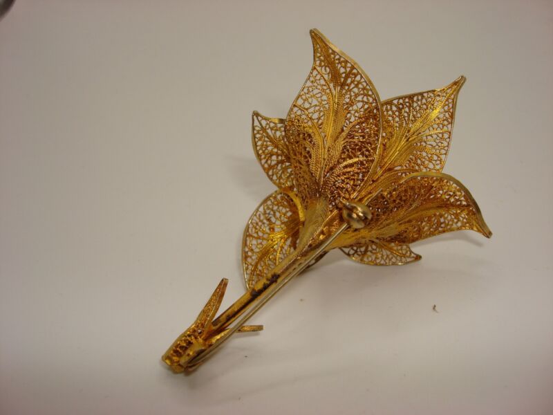 Vintage gold-washed spun silver lily brooch with intricate filigree detail