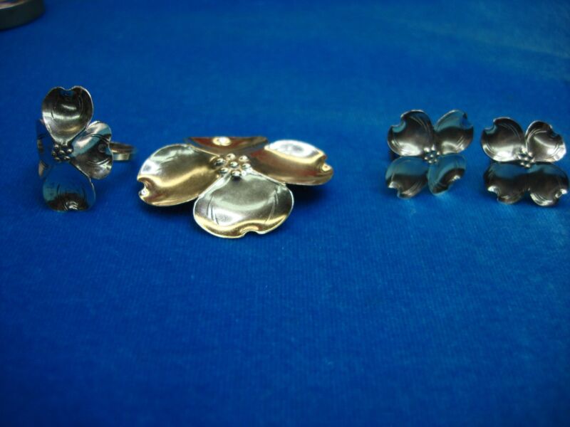 Vintage sterling silver dogwood flower jewelry set including a ring, earrings, and pin.
