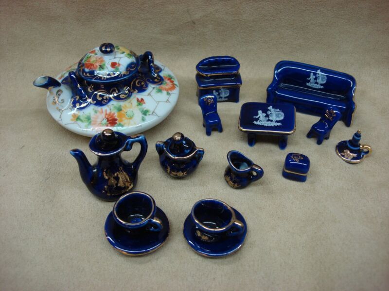 Vintage cobalt blue porcelain miniature set featuring a teapot, Limoges sideboard, and teacups