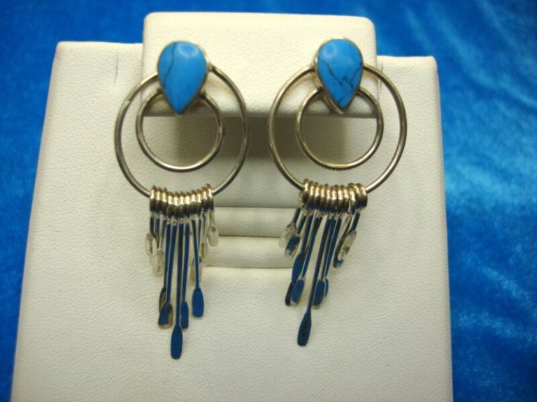 Sterling silver Native American dangle earrings with turquoise and canoe paddles
