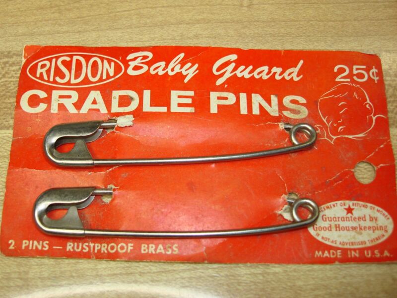 Vintage pair of Risdon Baby Guard cradle pins in original card display.