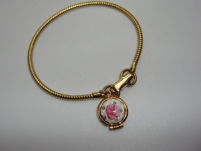 Vintage gold-tone snake chain bracelet with a guilloche rose locket