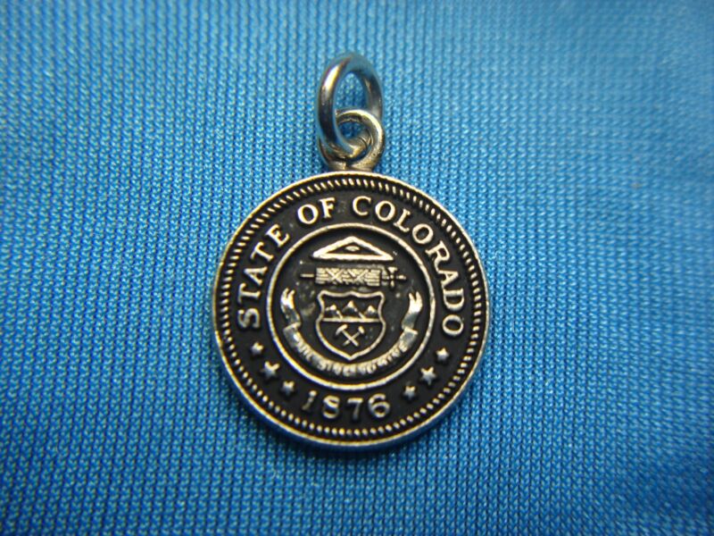 Vintage silver charm commemorating the 1965 John Deere Farm Convention in Denver, Colorado.