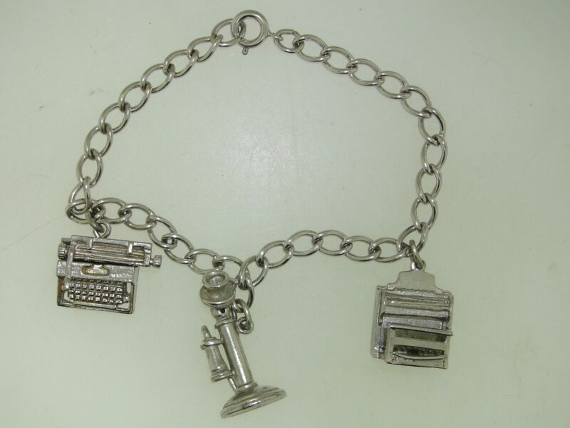 Vintage sterling silver charm bracelet with three working mechanical charms (1960s)