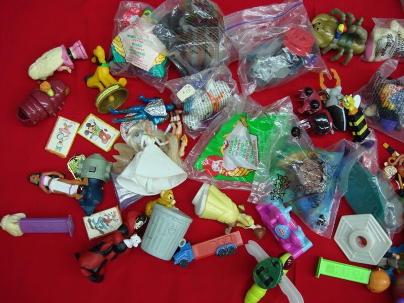 Vintage McDonald's toys, cereal premiums, PEZ dispensers, and Disney collectibles in a nostalgic lot.