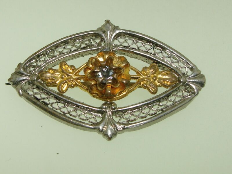 Antique Victorian filigree pin brooch with silver and gold-washed rhinestones.