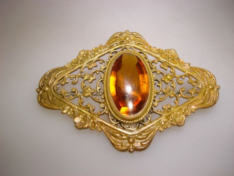 Antique Fisher & Nessler Co. gold-washed filigree pin with amber glass