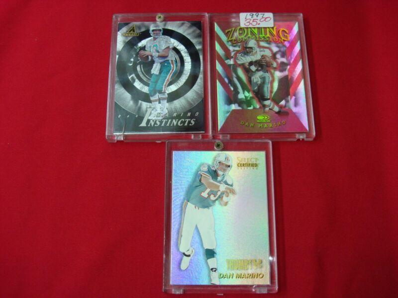 Vintage Dan Marino Miami Dolphins football cards from the 1990s, including certified and parallel inserts.