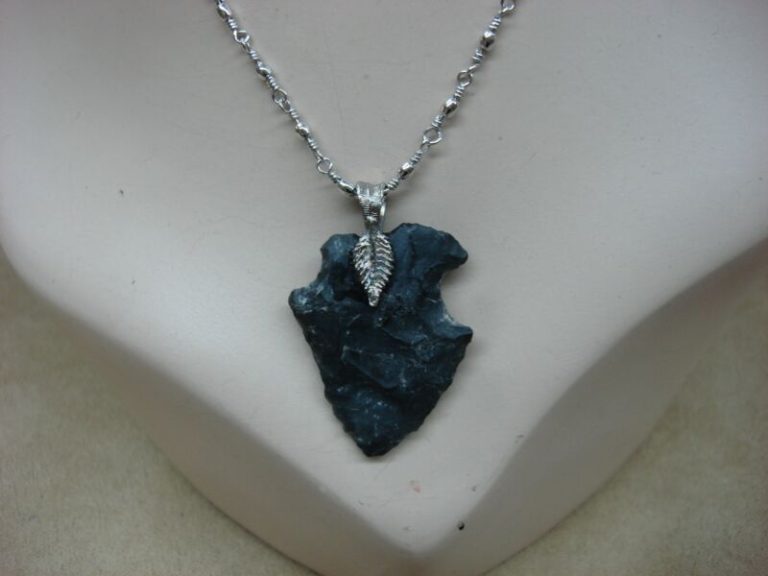 Authentic Native American arrowhead necklace with a Monet silver-tone chain.