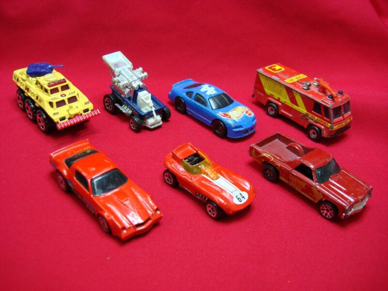 Collection of seven Hot Wheels and Matchbox cars including a Z28 Camaro, El Camino, Radio Flyer wagon and more.