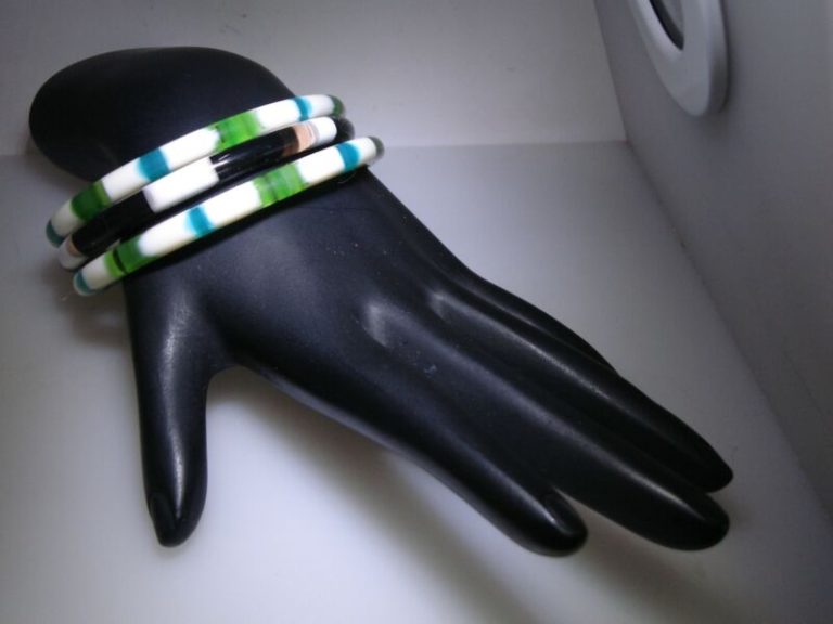 Set of three vintage Lucite bangle bracelets, candy stripe design in blue, green and white, and white and brown.