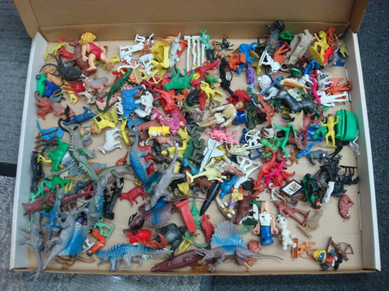 Vintage toy lot featuring Batman, McDonald's Transformers, Disney Army Men, circus figurines, farm animals, cowboys, and Native Americans.