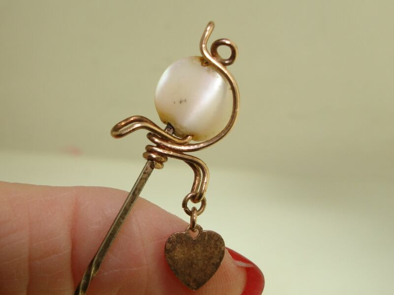 Antique rose gold filled stick pin with a mother of pearl heart engraved with 'ATLANTA 95'