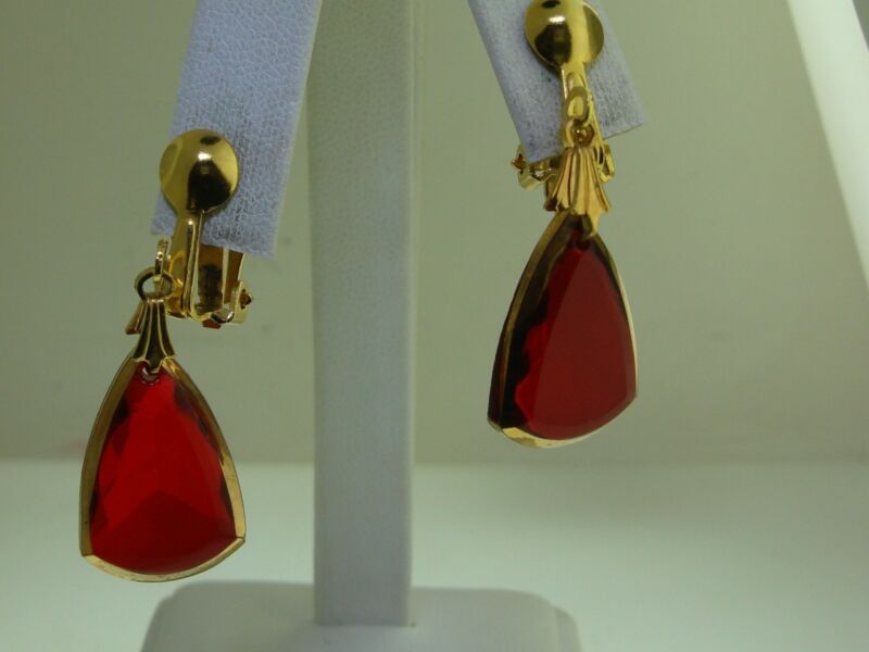 Vintage 1970s red dangle clip-on earrings with gold-tone metal and clear red glass stones.