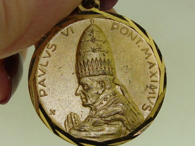 Vintage 1975 Pope Paul VI medal in gold tone, featuring an etched border and raised design.