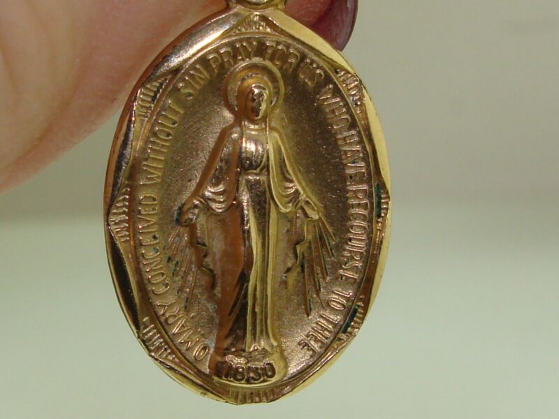 Vintage gold-filled Holy Mother Mary medal with intricate design and Creed signature