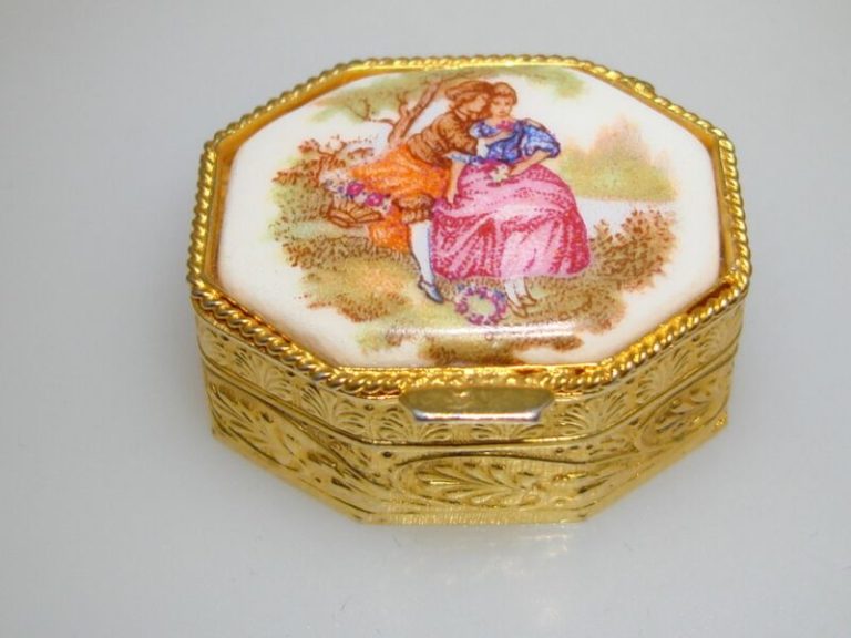 Vintage Limoges porcelain trinket box with a gold-tone finish and a garden scene lid