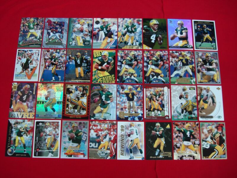 Collection of 32 Brett Favre football cards, including parallels, premiums, inserts, and a magnet.