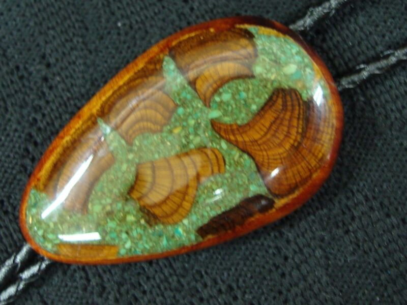 Vintage Native American bolo tie featuring a petrified wood fossil set with turquoise.