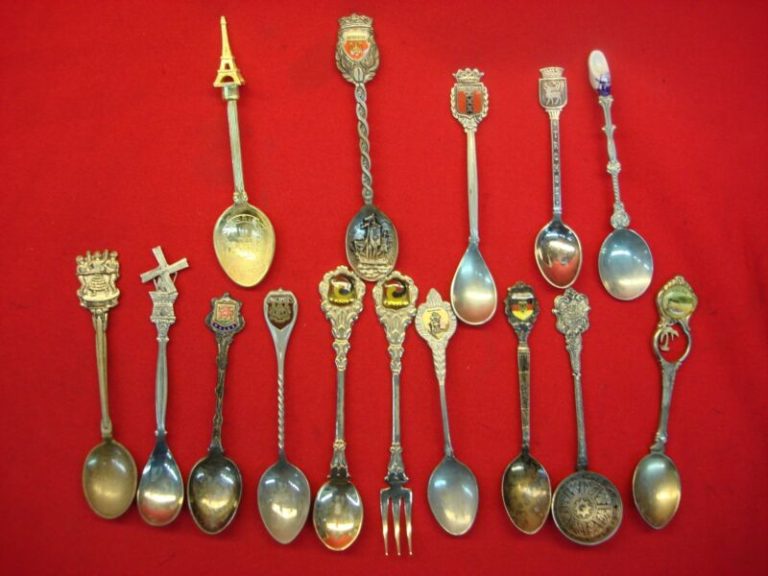 Vintage souvenir spoon collection featuring 15 unique spoons from various world countries and towns.