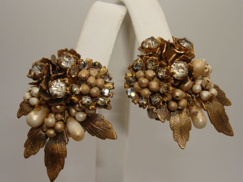 Vintage DeMARIO clip-on earrings featuring ornate leaves, pearls, and rhinestones.