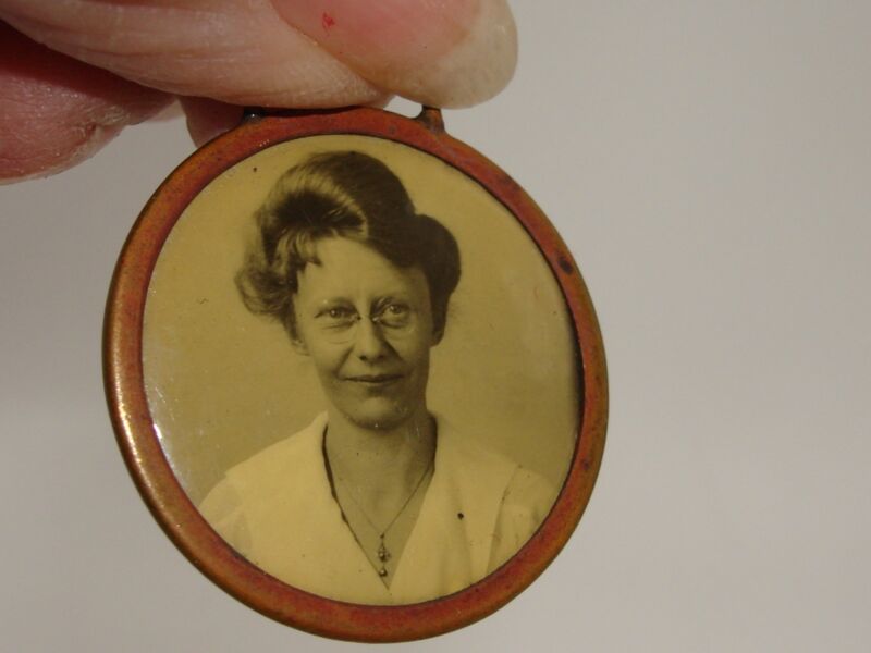 Vintage 1920s celluloid photo fob featuring a charming portrait of a young woman in Art Deco style.