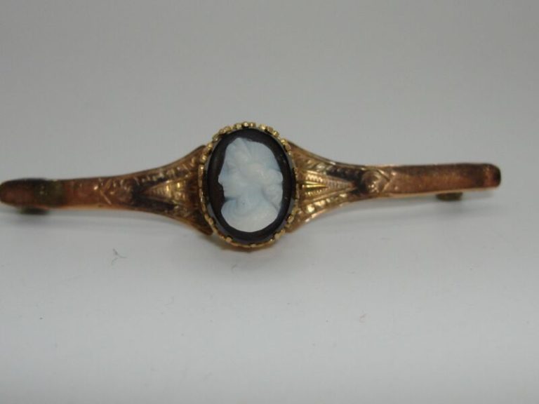 Antique Edwardian 10K gold cameo brooch with carved onyx and silver frame