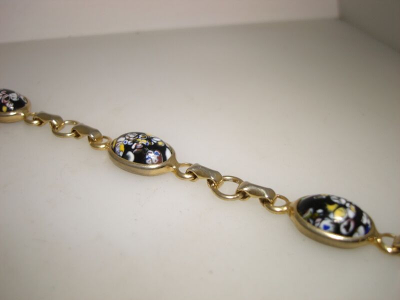 Vintage 1960s black millefiore glass bracelet with gold-tone metal.