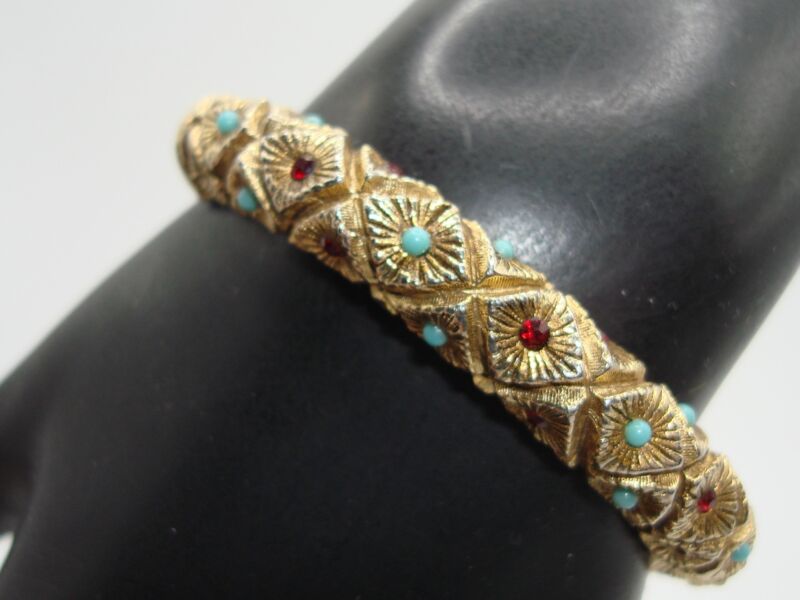 Vintage 1970s gold tone starburst bangle bracelet with faux turquoise and ruby stones