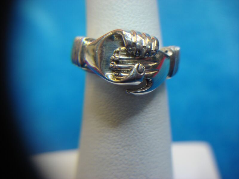 Sterling silver ring with clasped hands and heart motif, hinged design, size 4.75