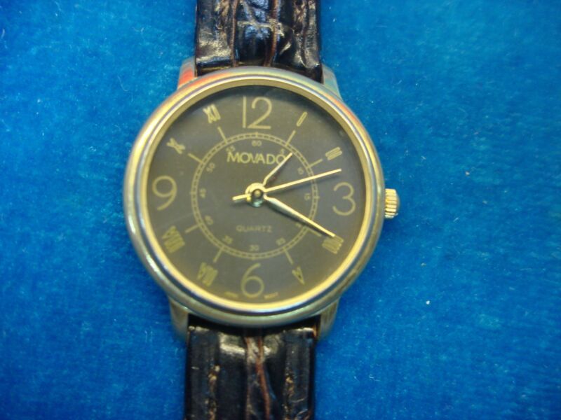 Vintage Movado quartz wristwatch with authentic leather band in excellent condition.