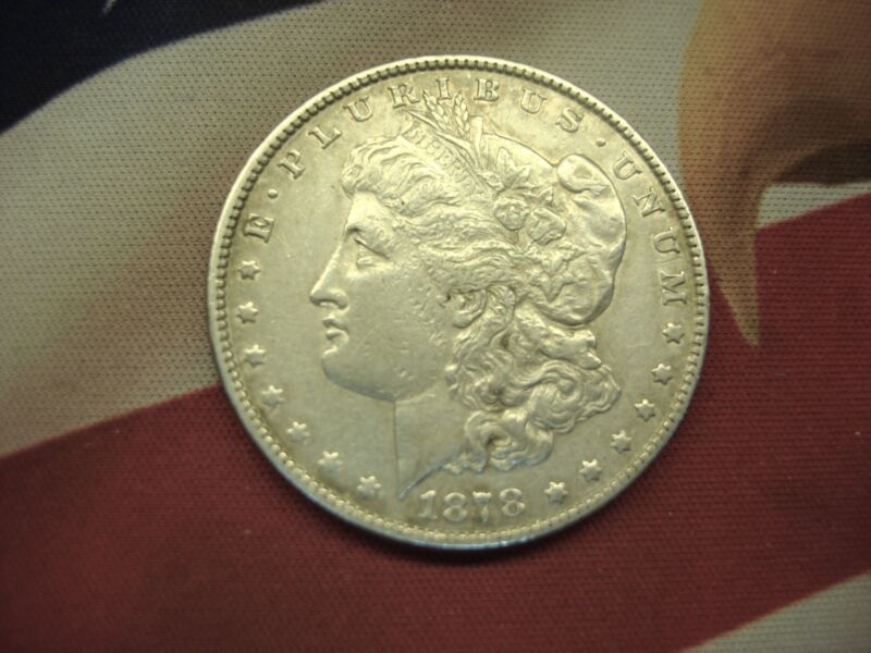 1878 Morgan Dollar with the '7 Tail Feather' reverse variety, uncleaned and in circulated condition