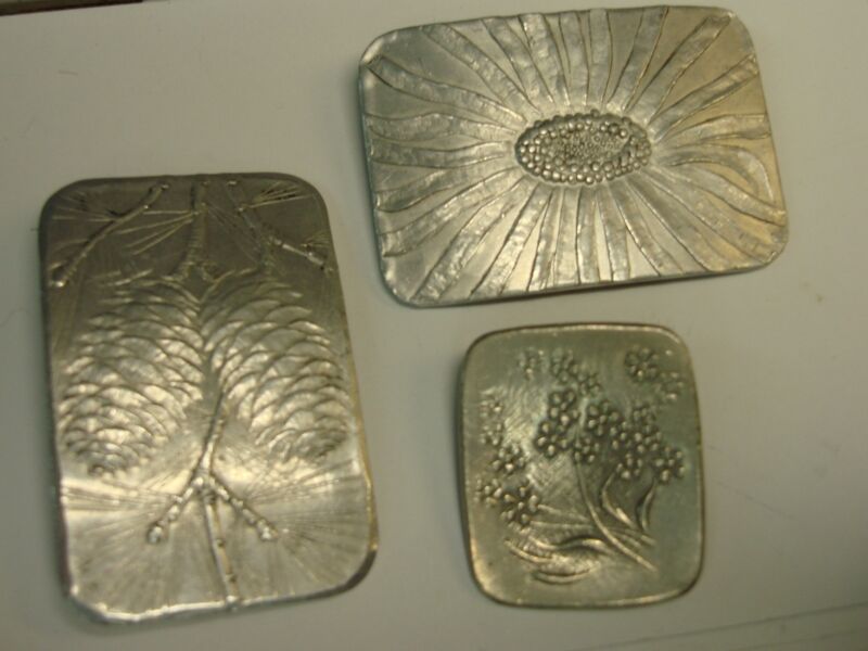 Three vintage artisan crafted signed pins featuring pine cone, sunflower and pewter designs.