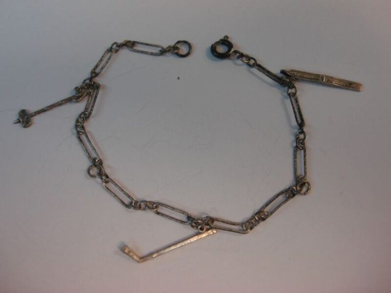Antique sterling bracelet with ski, hockey stick, and ski pole charms