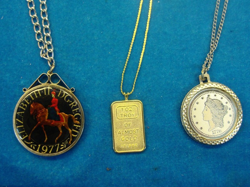 3 unique coin and bullion necklaces: a crown coin, gold replica, and almost gold pendant