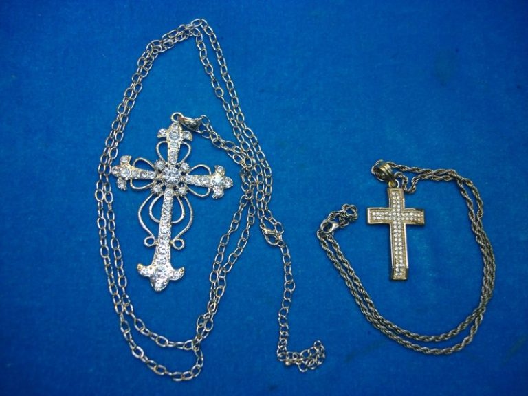 Two vintage cross pendants and necklaces from an estate collection.