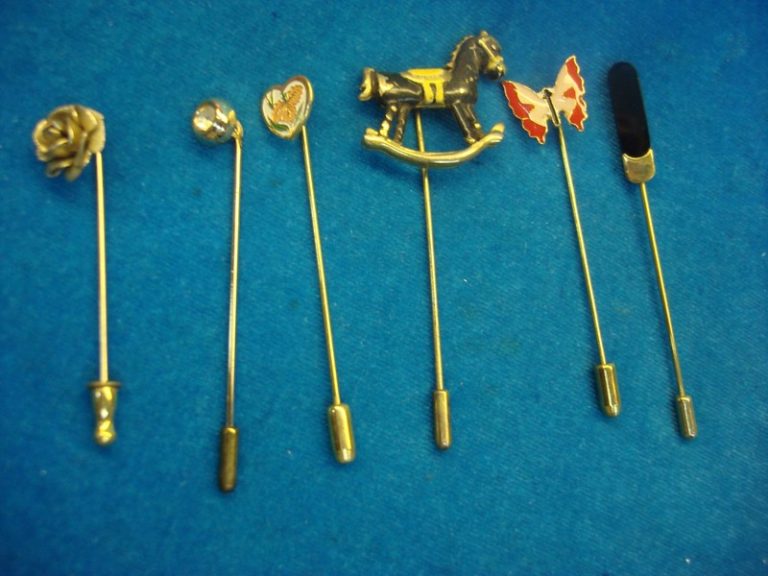 Six unique vintage stick pins with finger protector ends.