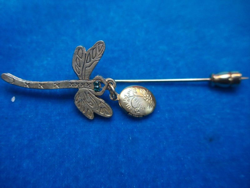Vintage gold-tone dragonfly pin with green glass eyes and a photo locket