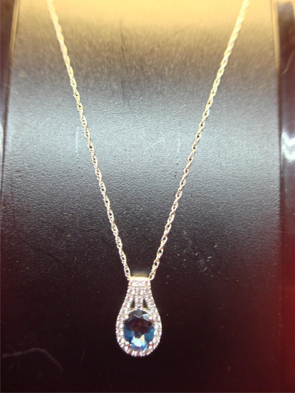 Sterling Silver Oval Topaz Pendant with White Topaz Accents