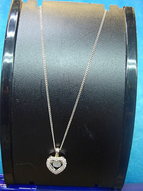 Sterling silver diamond heart pendant necklace with a floating diamond, offered in two lengths.
