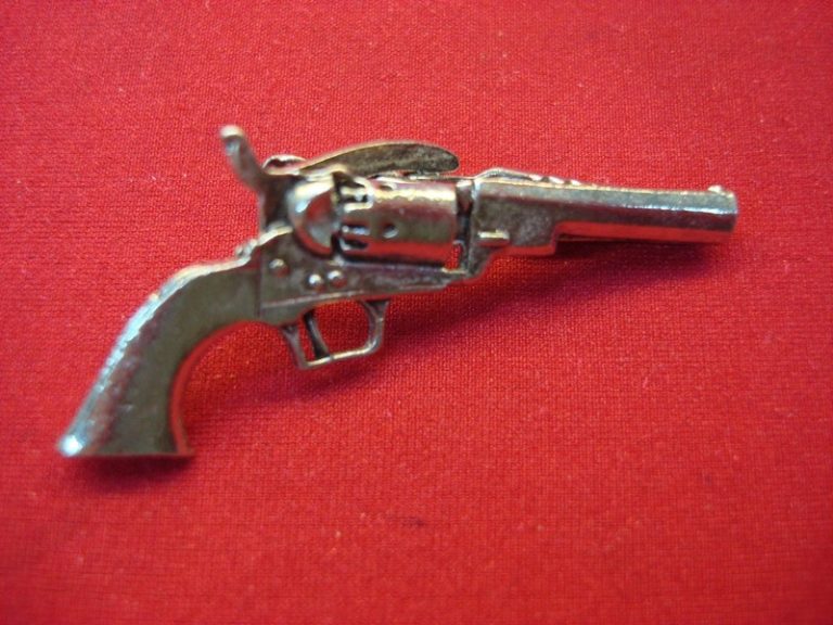 Vintage silver-tone metal tie clip with a detailed Old Time Cap & Ball revolver design.