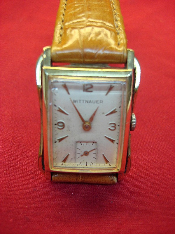 Vintage Wittnauer wristwatch with a unique design, featuring a 10K yellow gold filled case and a stainless steel back.