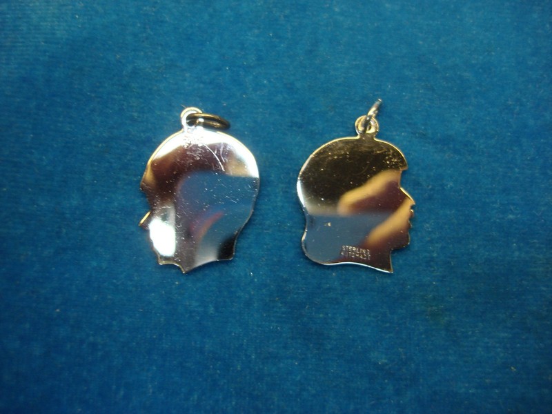 Pair of vintage Elco Sterling boy and girl head charms, new and unused