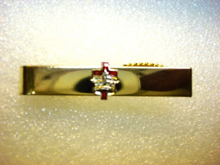 Vintage gold tone tie clip with red enamel cross and silver crown